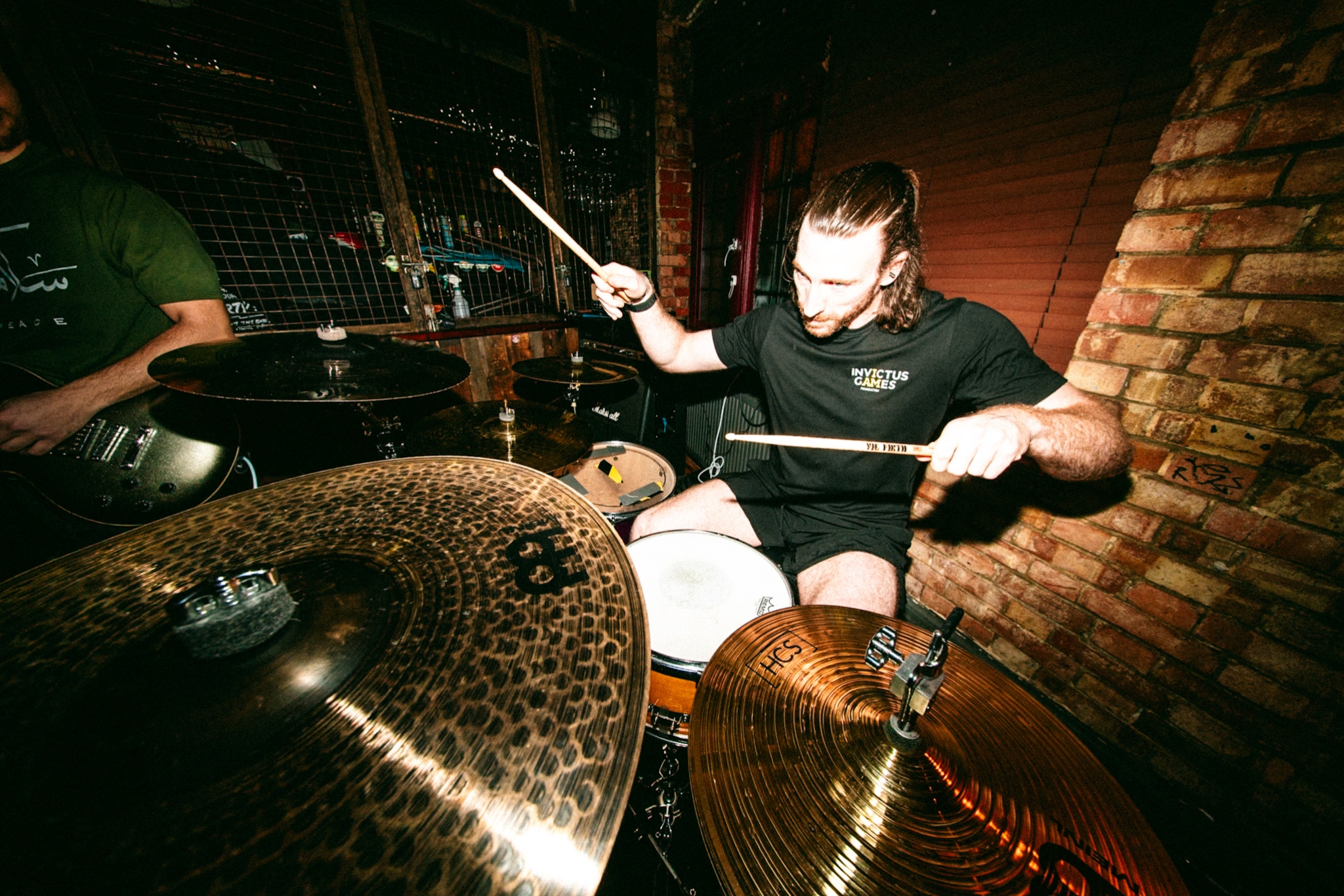 Photograph of a drummer behind a kit taken with a fisheye lens.